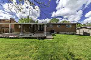 Rear view of property featuring a fenced backyard, brick siding, and a patio area