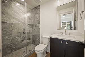 Bathroom with vanity, a marble finish shower, and a textured ceiling