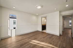 Spare room with dark wood-type flooring, recessed lighting, and a textured ceiling