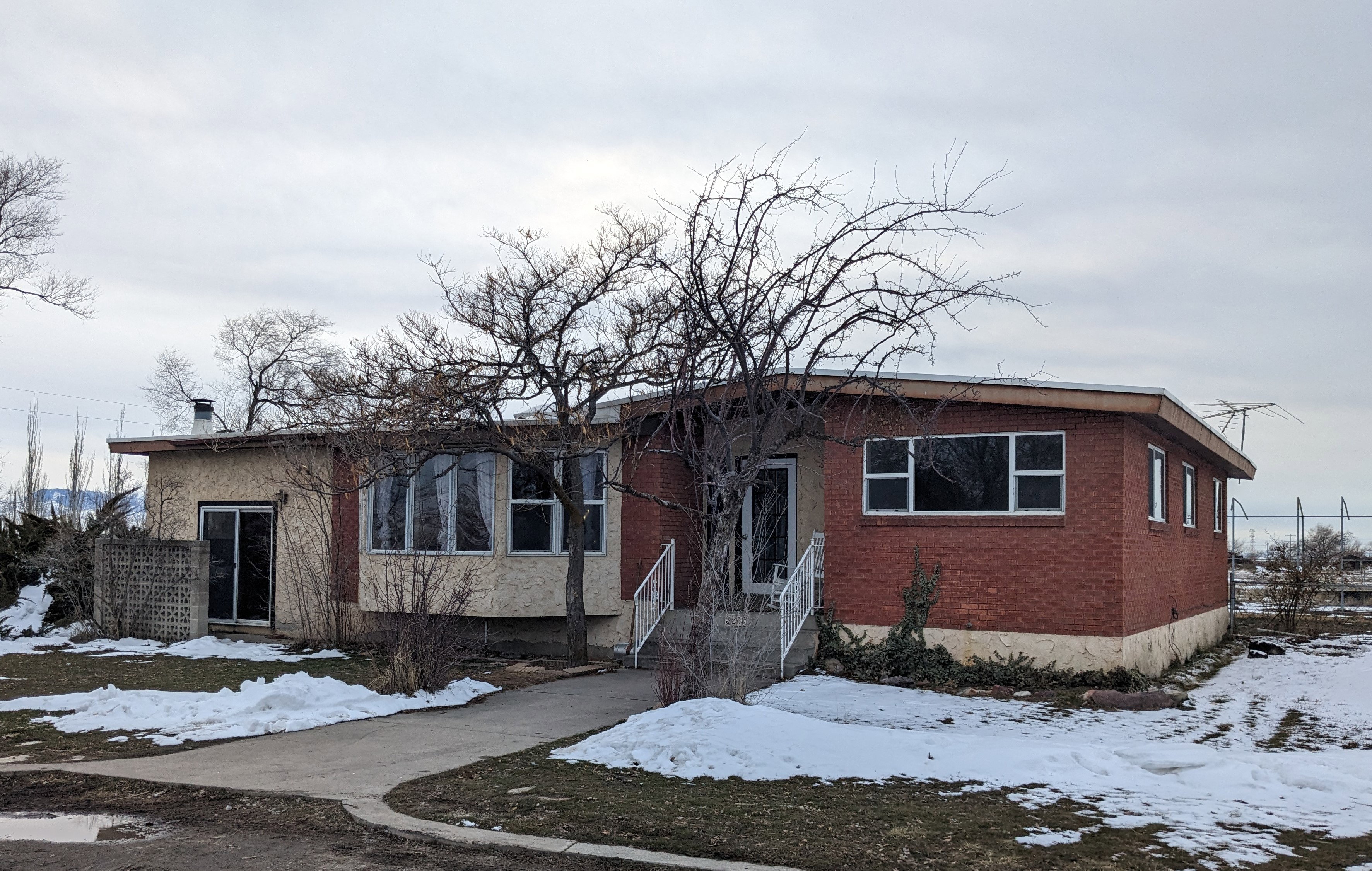 Bungalow-style house with brick siding