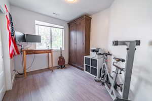 Office with light wood-style flooring and baseboards