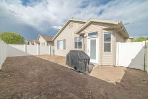 Back of property with a fenced backyard and a gate