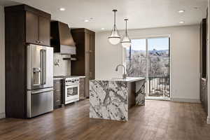 Kitchen with high quality appliances, light stone countertops, dark wood-type flooring, and dark wood finish cabinets