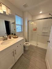 Full bathroom with vanity and a shower stall