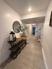 Entryway featuring a textured ceiling and baseboards