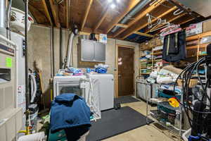 Unfinished below grade area featuring washing machine and dryer