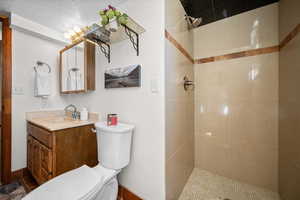 Bathroom featuring vanity and a shower stall