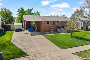 Ranch-style home featuring a front lawn, brick siding, and roof with shingles