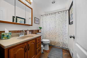 Bathroom with vanity, a shower with shower curtain, and a textured ceiling