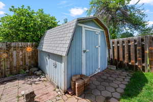 View of shed with a fenced backyard