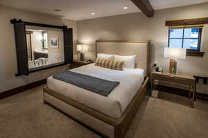 Bedroom featuring dark colored carpet, beamed ceiling, and recessed lighting