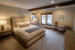 Carpeted bedroom with recessed lighting and beam ceiling