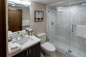 Full bathroom with vanity and a marble finish shower