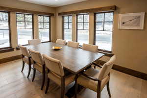 Dining area with baseboards and light wood-style floors