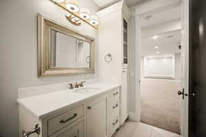 Bathroom with light carpet, vanity, and light tile patterned floors