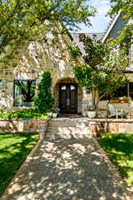 Entrance to property featuring french doors and stone siding