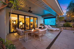 View of patio with an outdoor living space with a fire pit