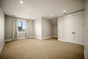 Additional living space featuring recessed lighting, light carpet, and vaulted ceiling