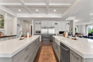 Kitchen featuring a large island, recessed lighting, glass insert cabinets, stainless steel appliances, and gray cabinetry