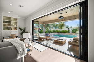 Fenced backyard with an outdoor living space with a fire pit, a patio, and a pool with connected hot tub