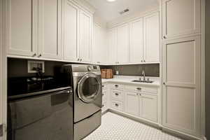 Laundry room with cabinet space and washer and dryer