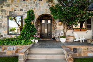Property entrance featuring stone siding