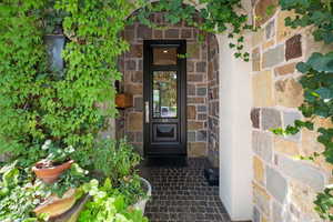 Property entrance featuring stone siding