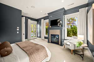 Bedroom with access to exterior, multiple windows, a tile fireplace, carpet floors, and recessed lighting