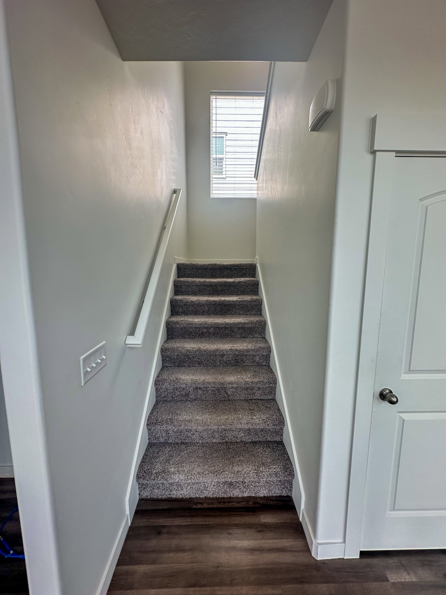 Staircase featuring baseboards and wood finished floors
