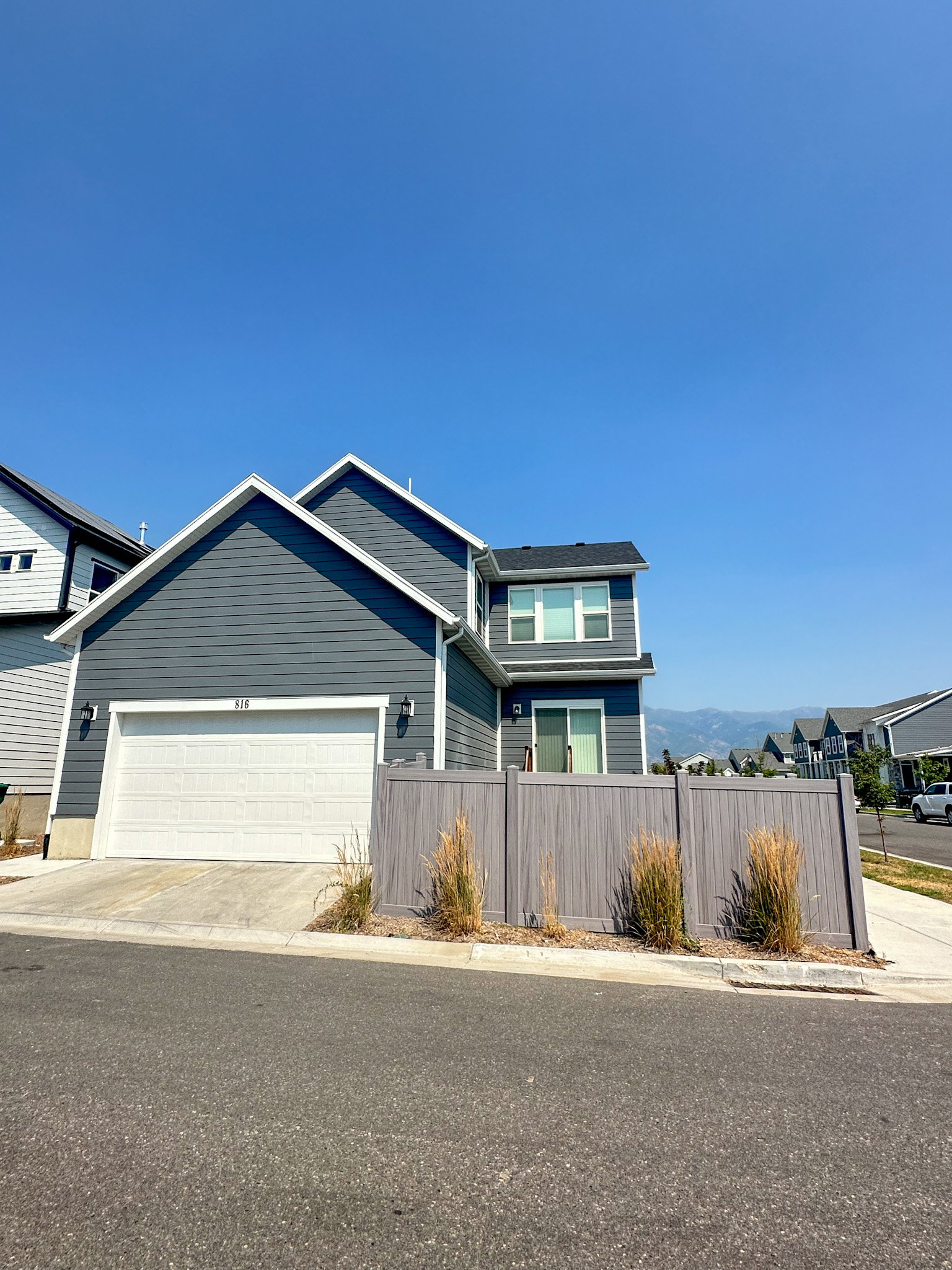 View of front of house featuring a garage and concrete driveway