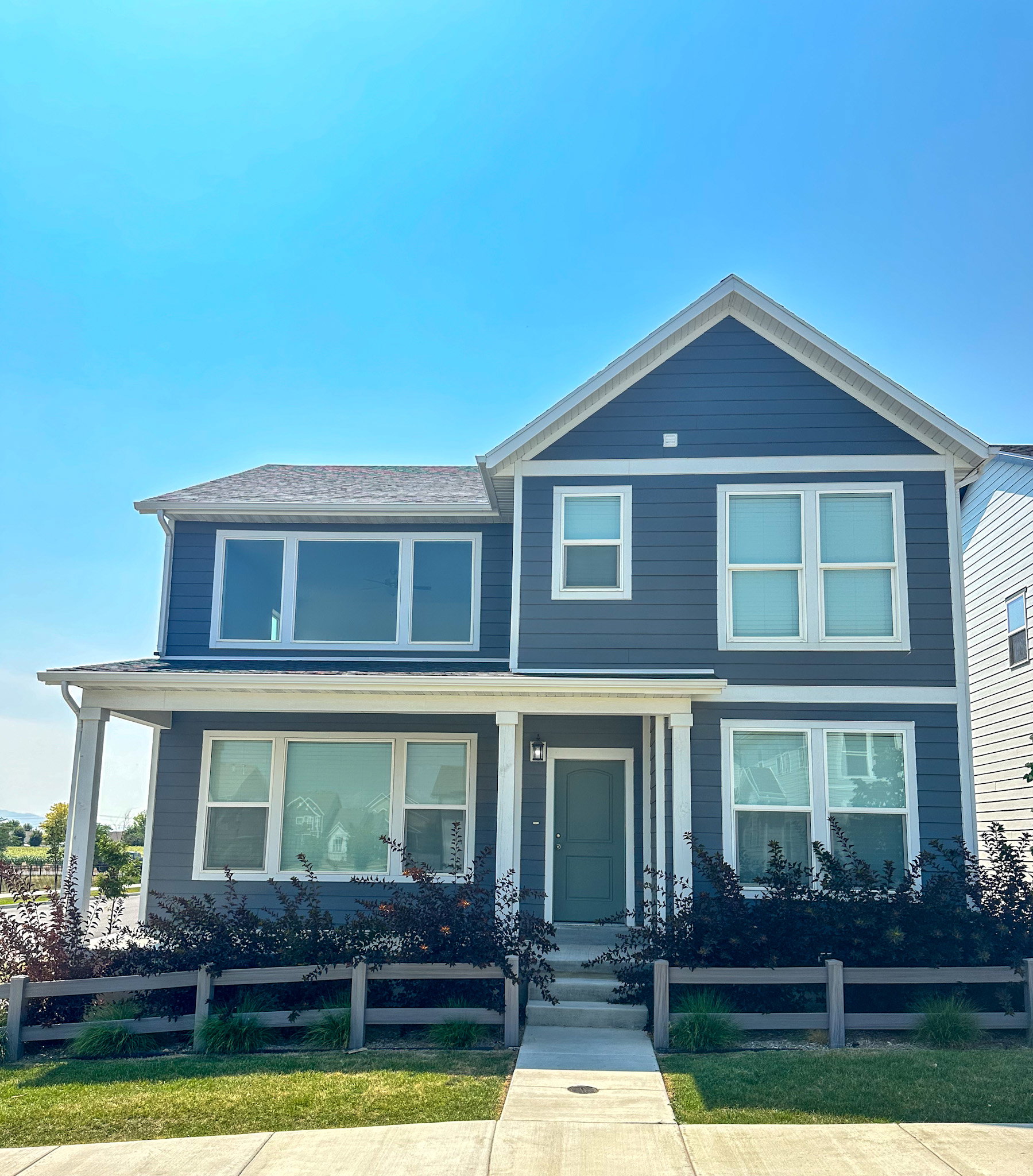 View of front of house with a porch and a fenced front yard