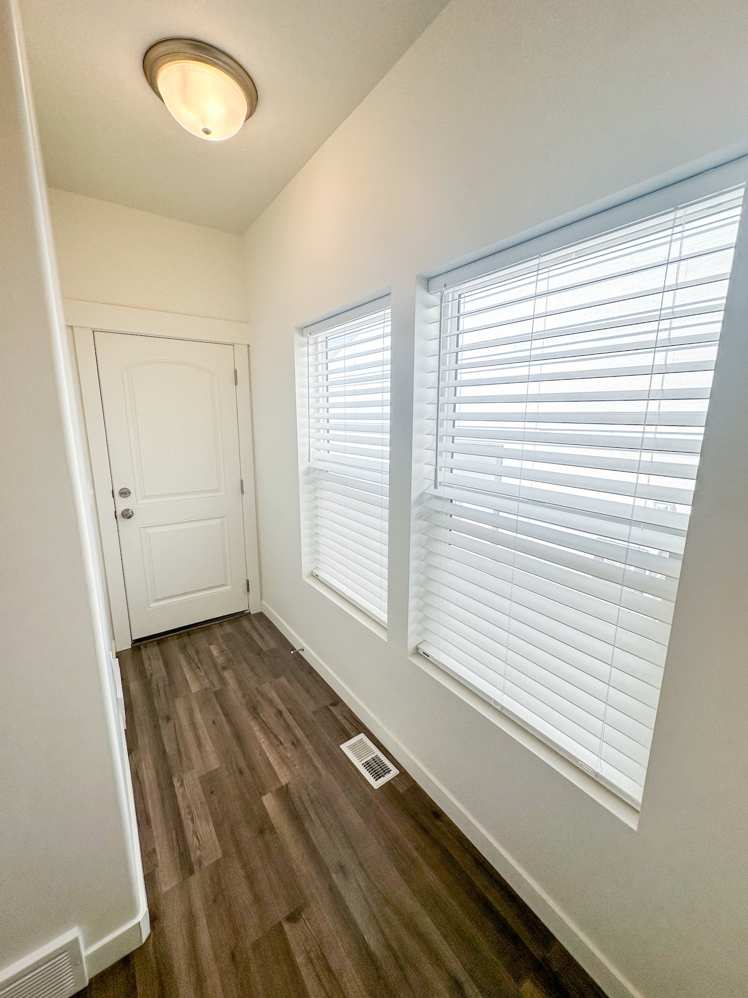 Entryway featuring baseboards and wood finished floors
