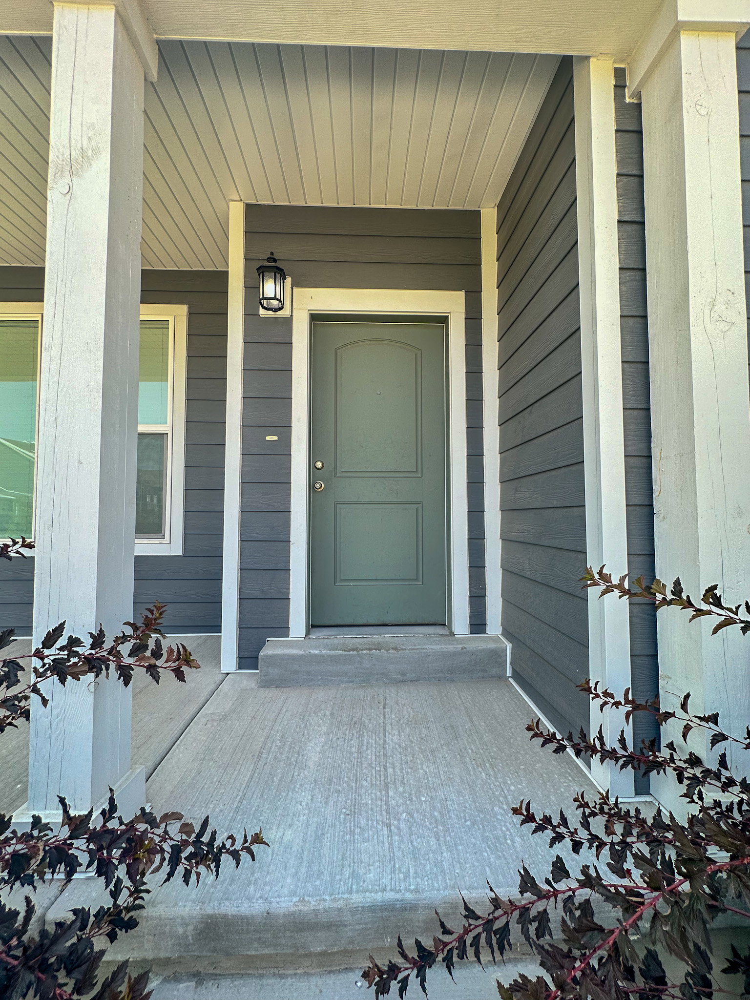 View of exterior entry with a porch