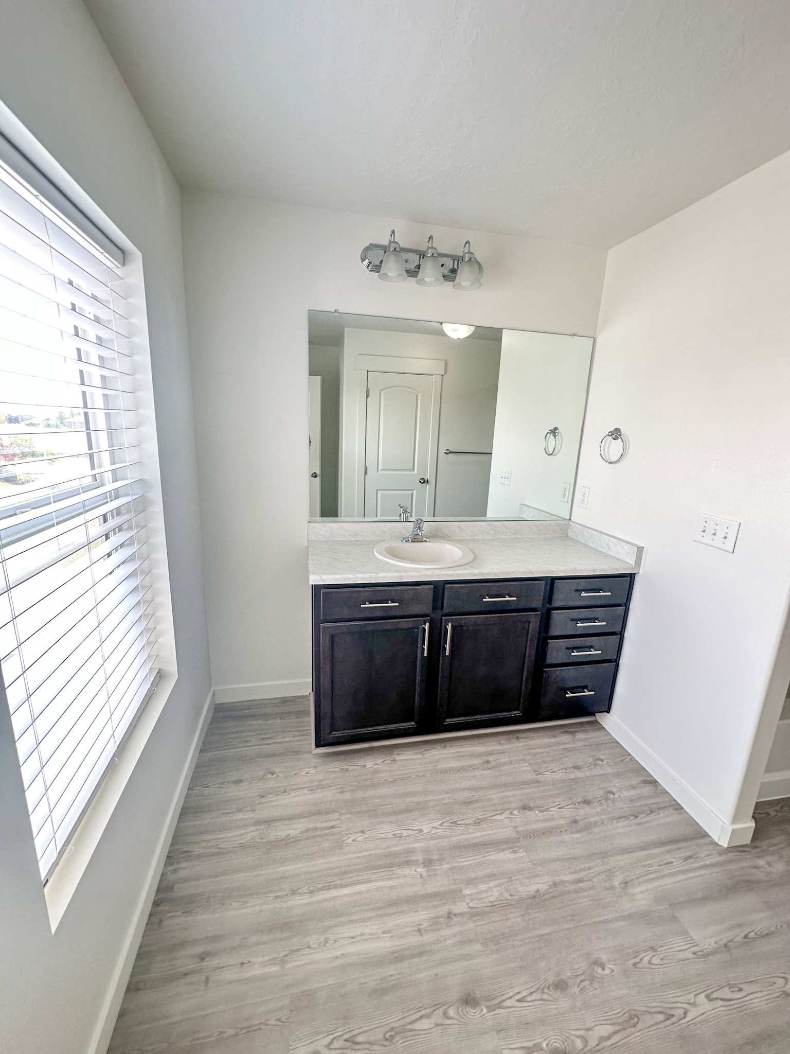 Bathroom featuring vanity and light wood-style floors