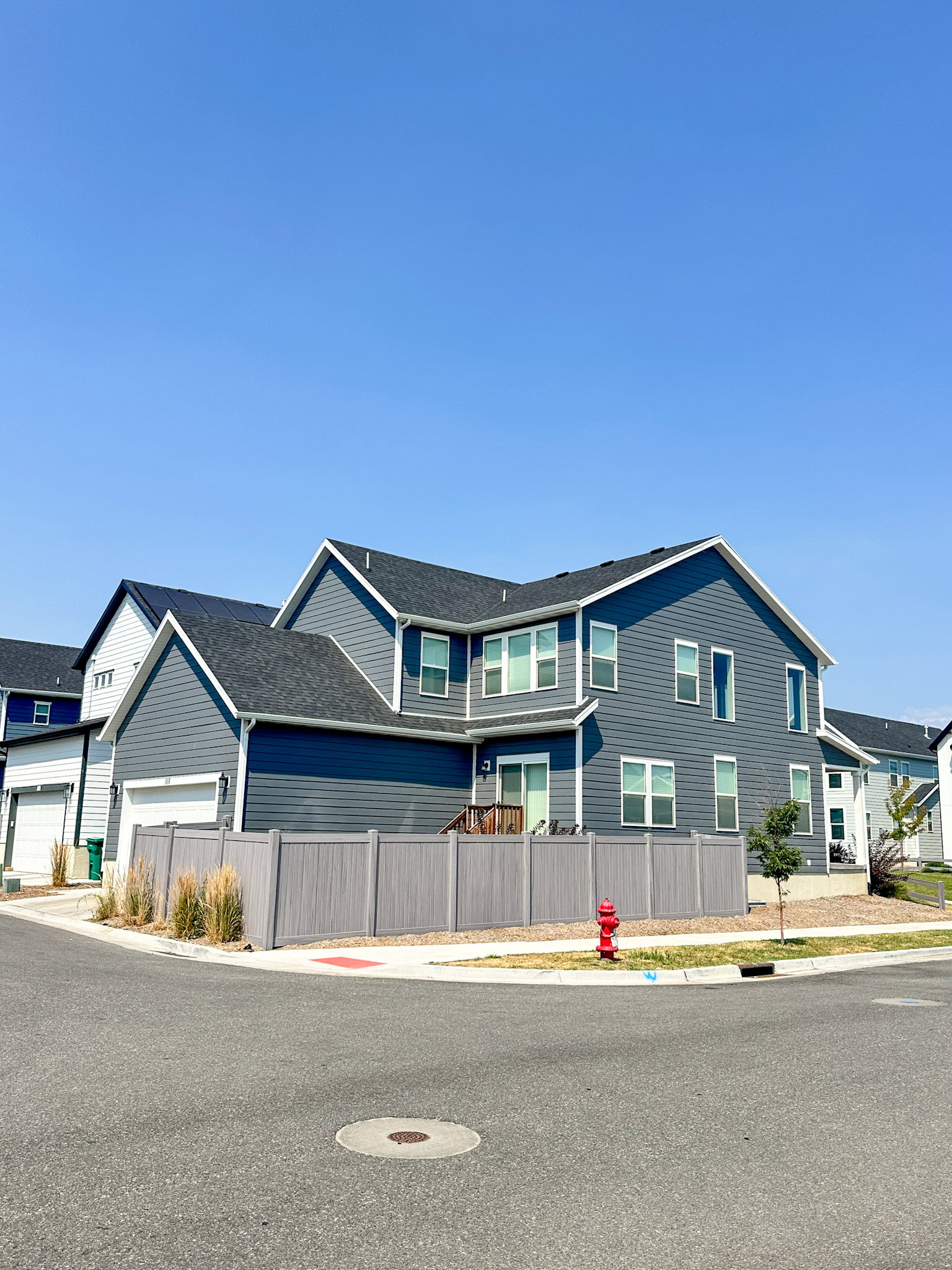 View of front of home with a fenced front yard and a garage