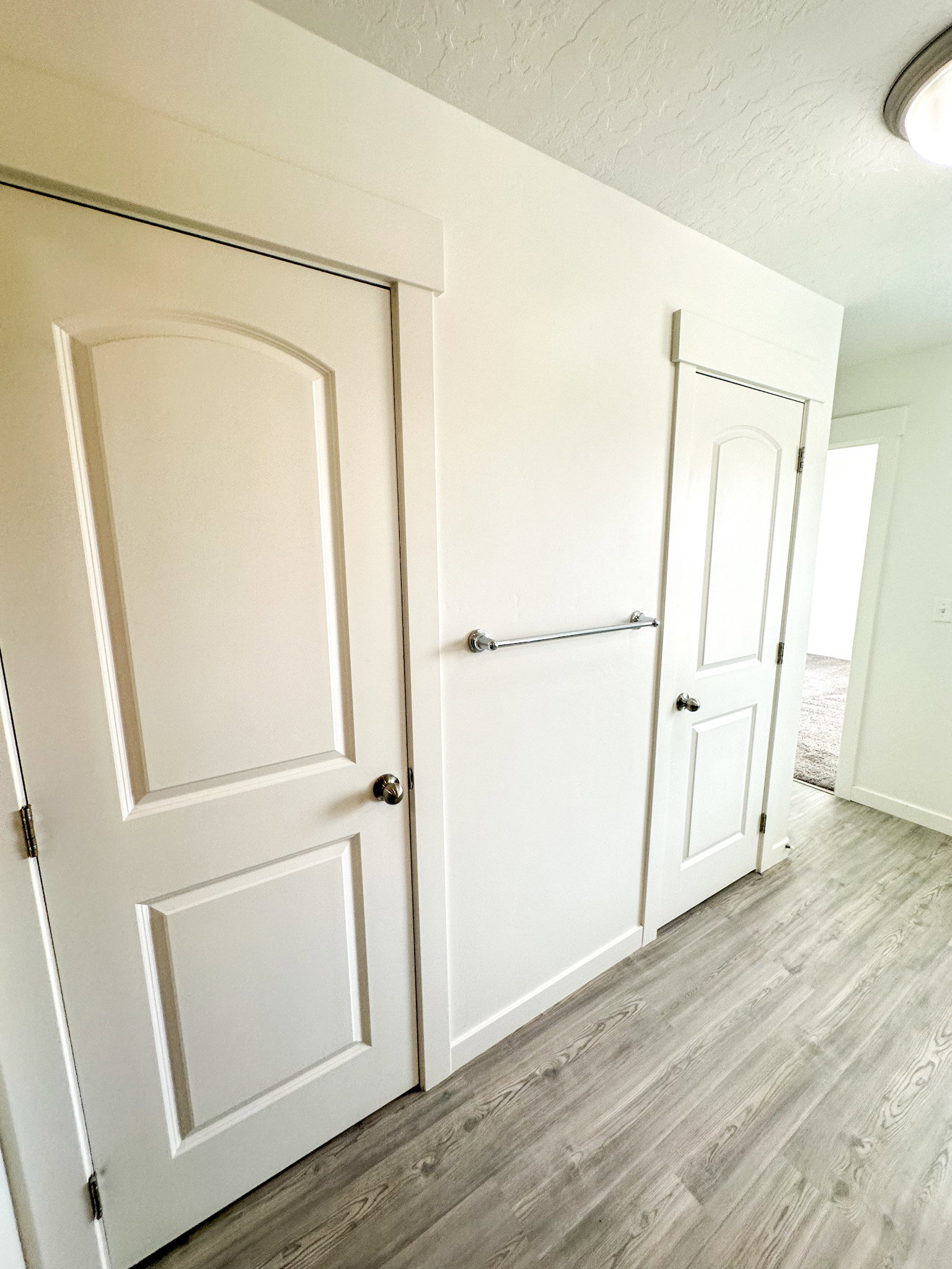 Unfurnished bedroom with light wood-style flooring, a textured ceiling, and a closet