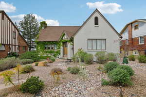 Tudor house featuring stucco siding and a shingled roof