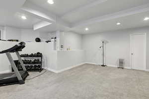 Workout room featuring carpet flooring, recessed lighting, and radiator