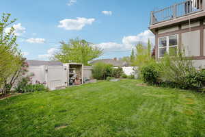 Fenced backyard with an outbuilding