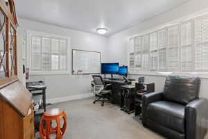 Office area featuring baseboards and light colored carpet