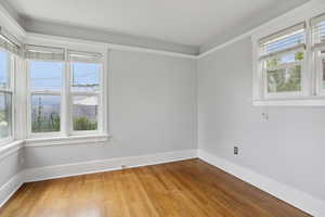 Unfurnished room featuring light wood-style floors and baseboards