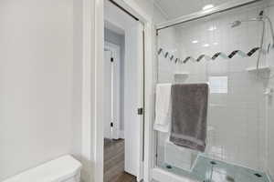 Bathroom featuring a stall shower and wood finished floors