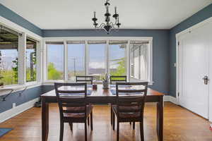 Dining room with hanging lights and wood finished floors