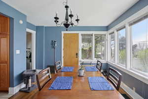 Dining space with suspended lighting and wood finished floors