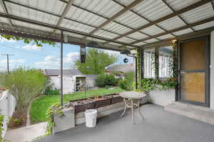 Sunroom featuring a patio area