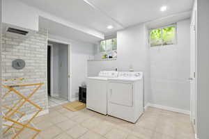 Laundry area featuring recessed lighting and washer and clothes dryer