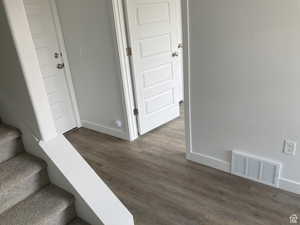 Stairs with baseboards and wood finished floors