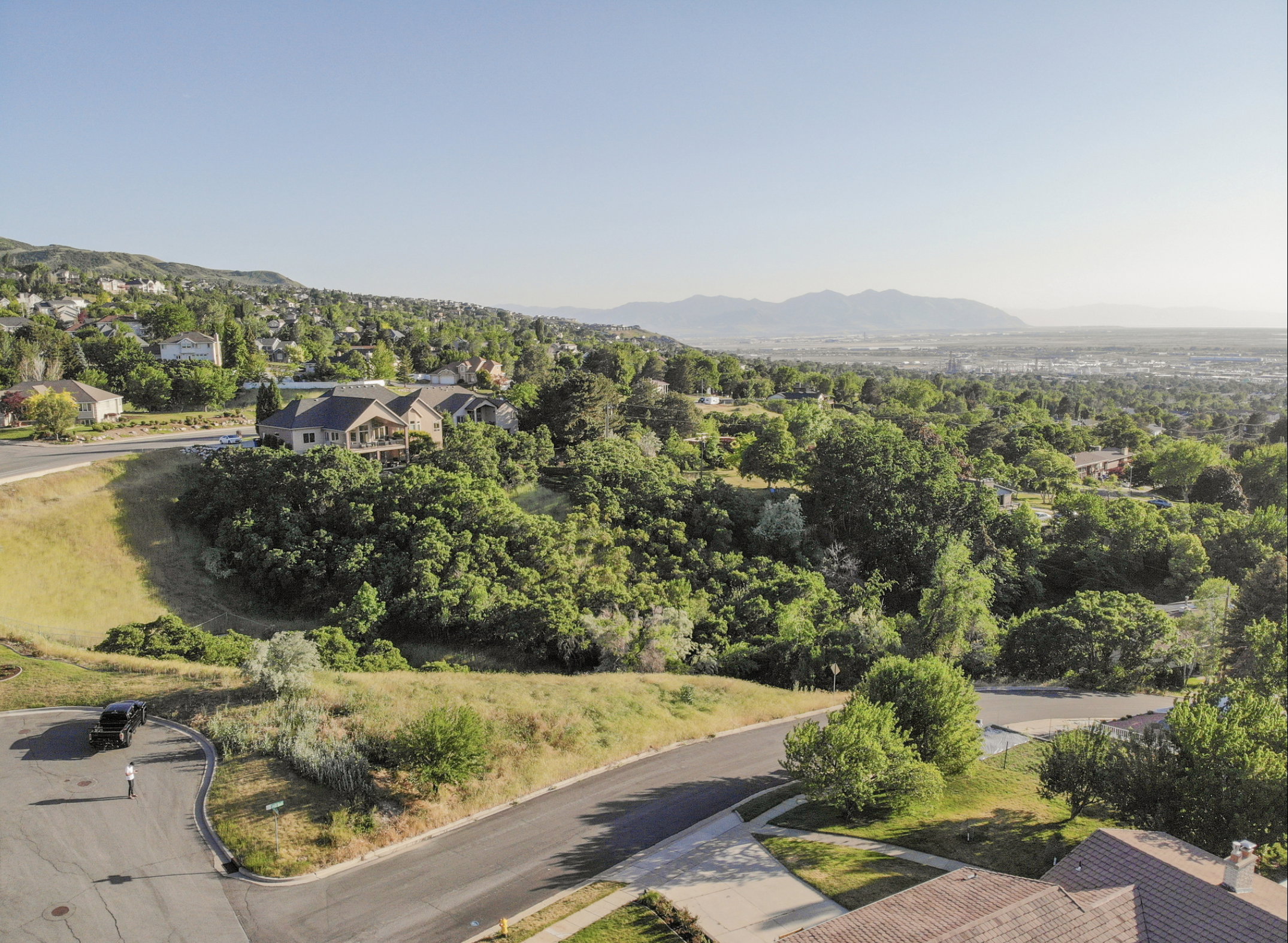 Aerial perspective of suburban area with a mountainous background