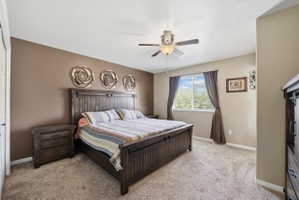 Bedroom featuring light colored carpet and ceiling fan