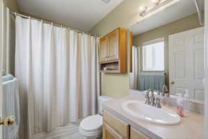 Bathroom featuring vanity and shower / tub combo with curtain